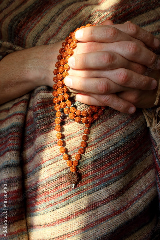 Rudraksha beads in men's hands in traditional indian shawl. Man counting  religious beads in sunlight. Religion and pray background. Stock Photo |  Adobe Stock