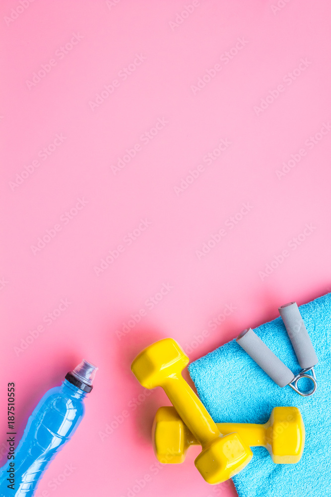 Equipment for sport exercise. Fitness background. Dumbbells, expander on  pastel pink background top view copy space Stock Photo