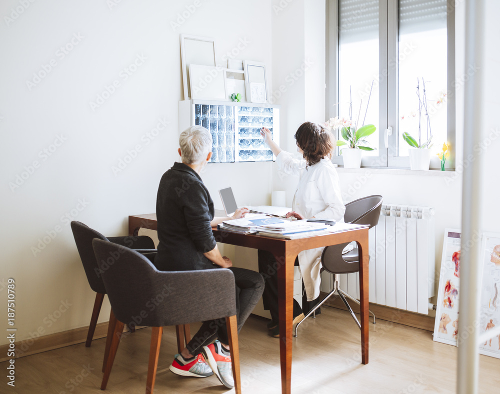 Physician Showing Spine Scan to her Patient Physician Showing Spine Scan to her Patient