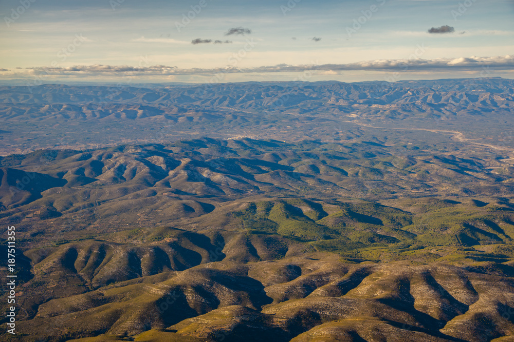 Fototapeta Repeatable soft mountain peaks pattern aerial view from airplane high above