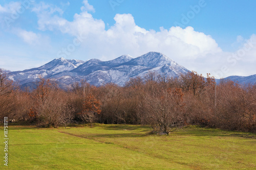 Landscape with blue sky, snowy mountains and green grassland. Bosnia and Herzegovina, Tuli region