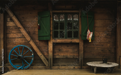 Old wooden cottage /facade detail with slavic motivs on it. photo
