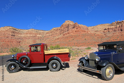 Old vintage cars driving Moki Dugway road leading to the Valley of the Gods, Utah, USA