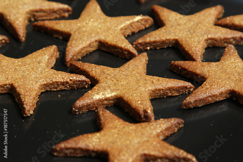Star shaped cookies (biscuits) on a steel pan.