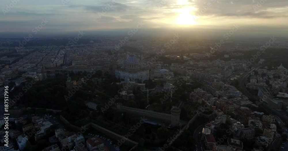 ROME, ITALY – OCTOBER 2015 : Aerial shot over Vatican City at sunset with St Peter's Basilica and central Rome cityscape in view ROME, ITALY – OCTOBER 2015 : Aerial shot over Vatican City at sunset with St Peter's Basilica and central Rome cityscape in view
