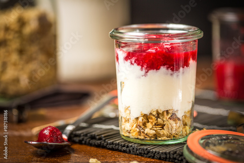Closeup of Granola with Red Berries and Kefir on a table