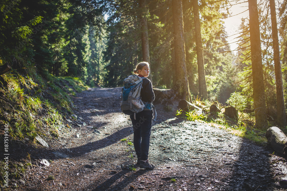Fototapeta premium Teen Hiker Walks in Forest