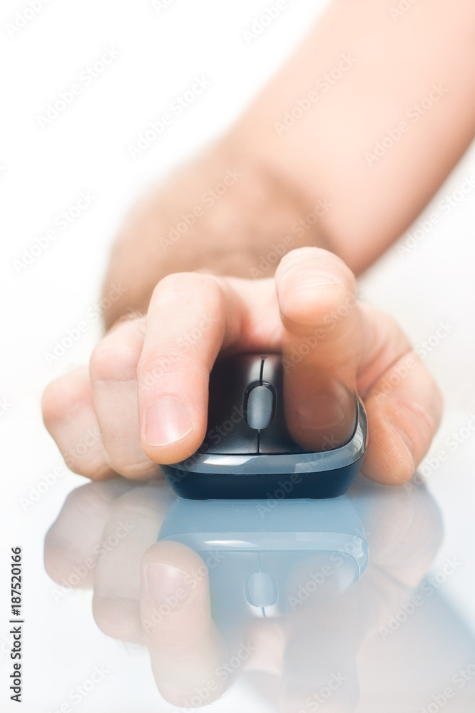 Human hand with computer mouse in hand on smooth surface close-up Human hand with computer mouse in hand on smooth surface close-up