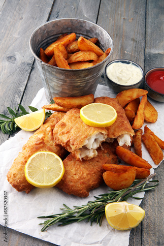 Photography traditional British fish and chips with potato and lemon