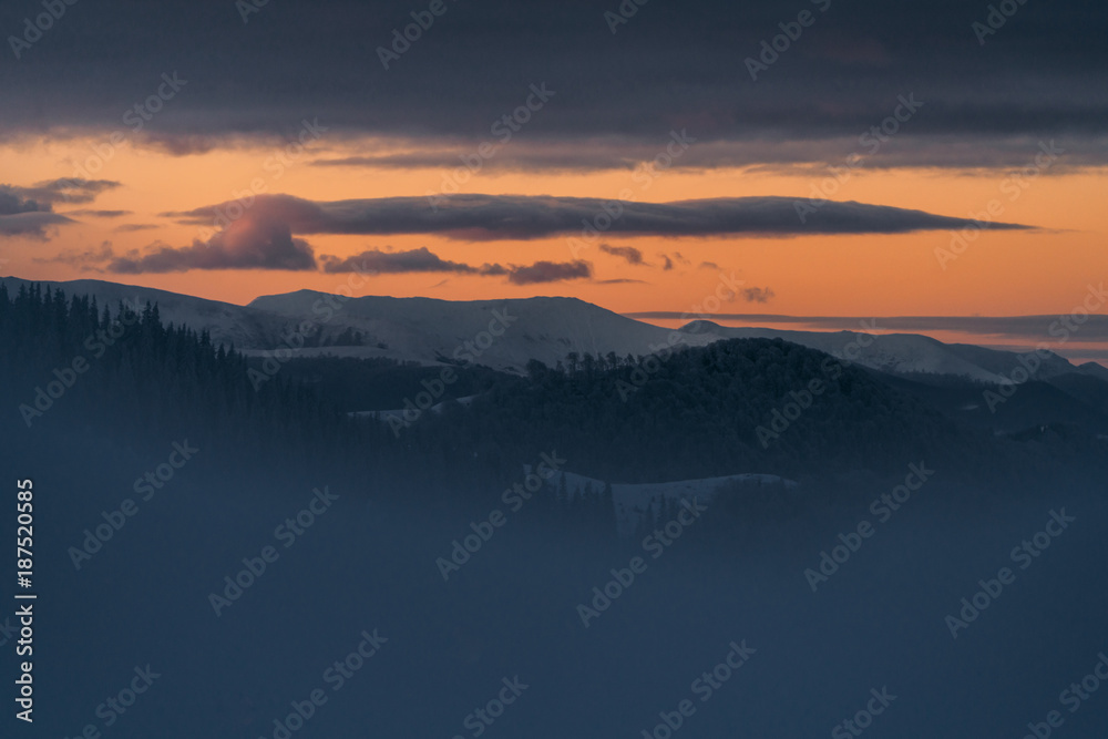 Beautiful sunrise light over the peaks, winter landscape 