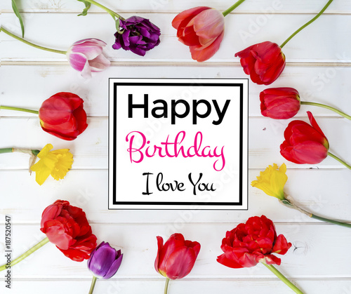 Happy Birthday Greeting Card with Tulips Frame on a White Wooden Background