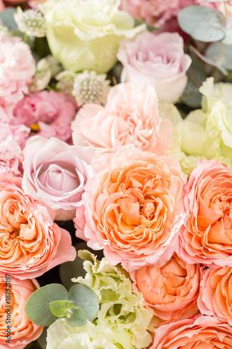 Fototapeta Naklejka Na Ścianę i Meble -  beautiful bouquet of mixed flowers in a vase on wooden table. the work of the florist at a flower shop