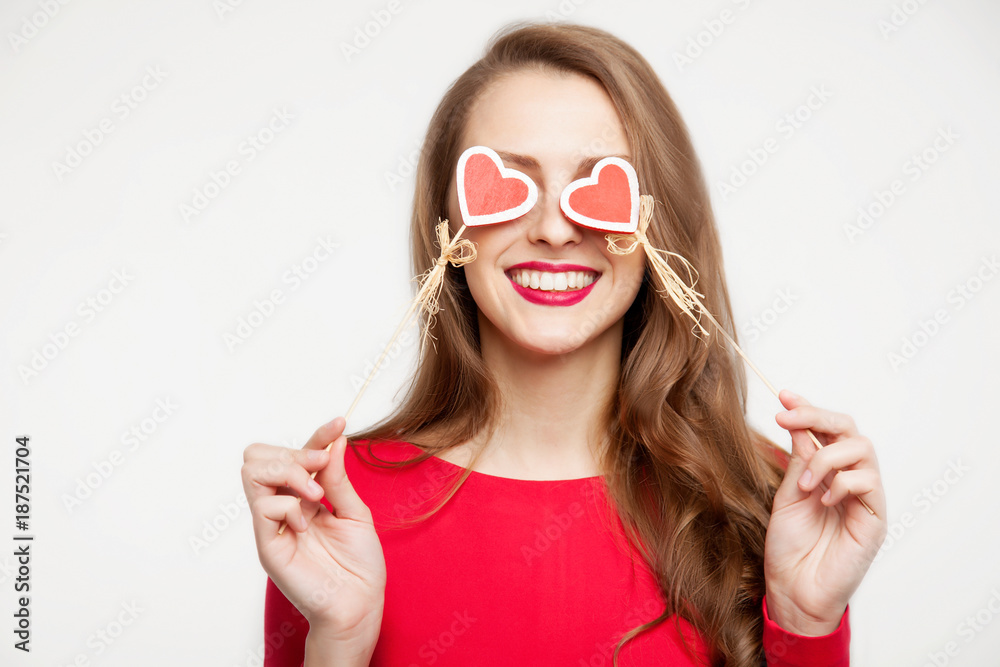 beautiful brunette girl closed her eyes with two hearts of souvenirs. Valentine's day concept. On white background. Place for text beautiful brunette girl closed her eyes with two hearts of souvenirs. Valentine's day concept. On white background. Place for text