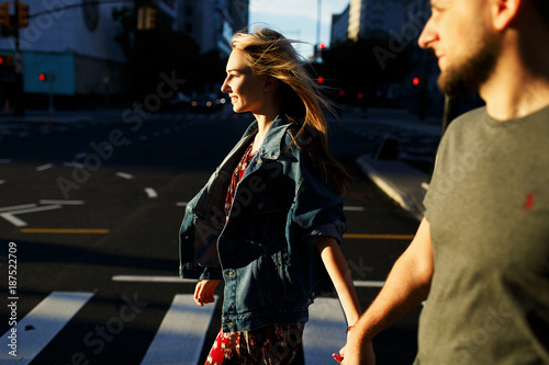 Lovely young couple dressed in casual style walks around Soho and New York city in morning lights photo