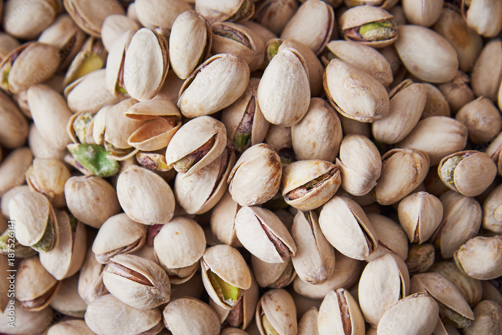 Pile of roasted and salted pistachios in shell Pile of roasted and salted pistachios in shell