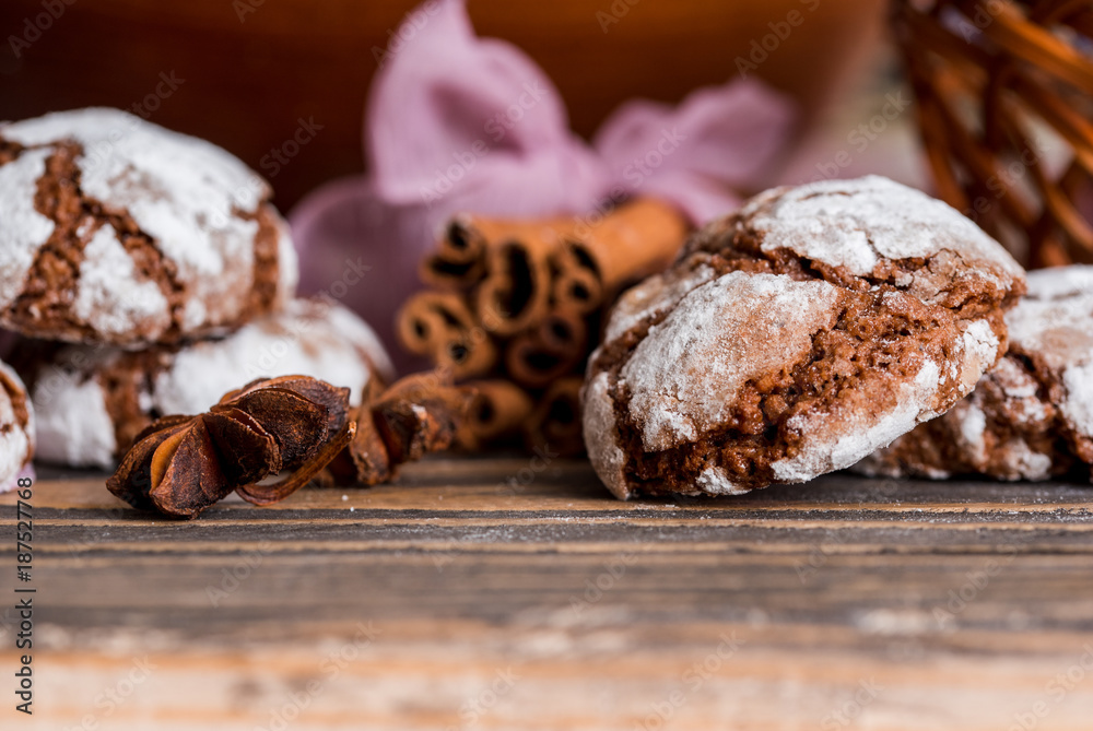 biscuits with chocolate cracks. Morning breakfast. On a wooden plate on a dark textured wooden background. Lavender and cardamom, cinnamon sticks on a purple napkin with ribbon. Place for inscription biscuits with chocolate cracks. Morning breakfast. On a wooden plate on a dark textured wooden background. Lavender and cardamom, cinnamon sticks on a purple napkin with ribbon. Place for inscription