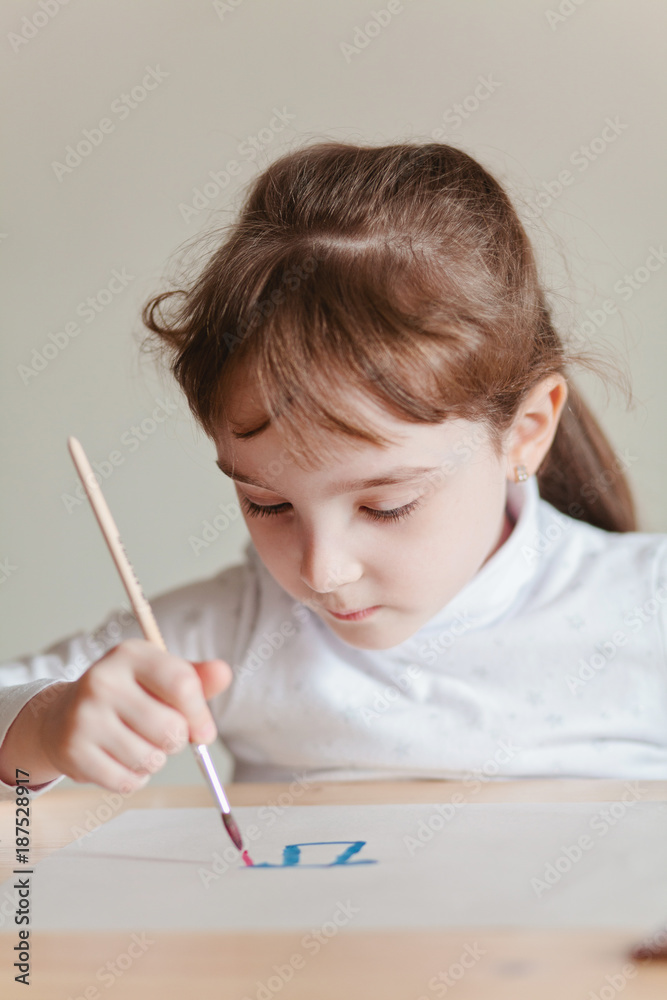 Little girl doing painting with watercolor Little girl doing painting with watercolor