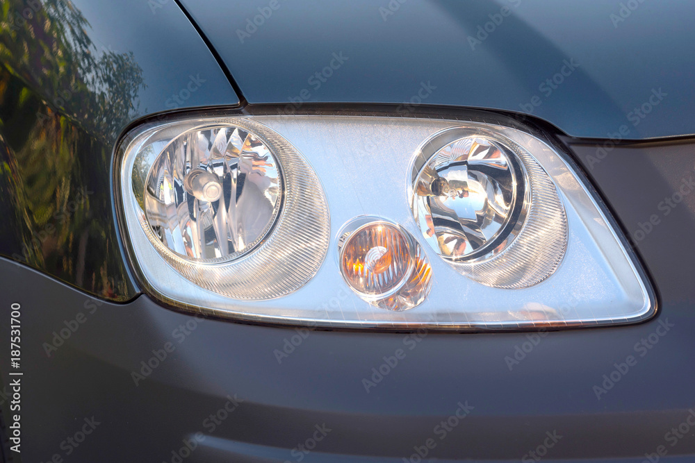 Right headlight during the day. Automobile detail close-up