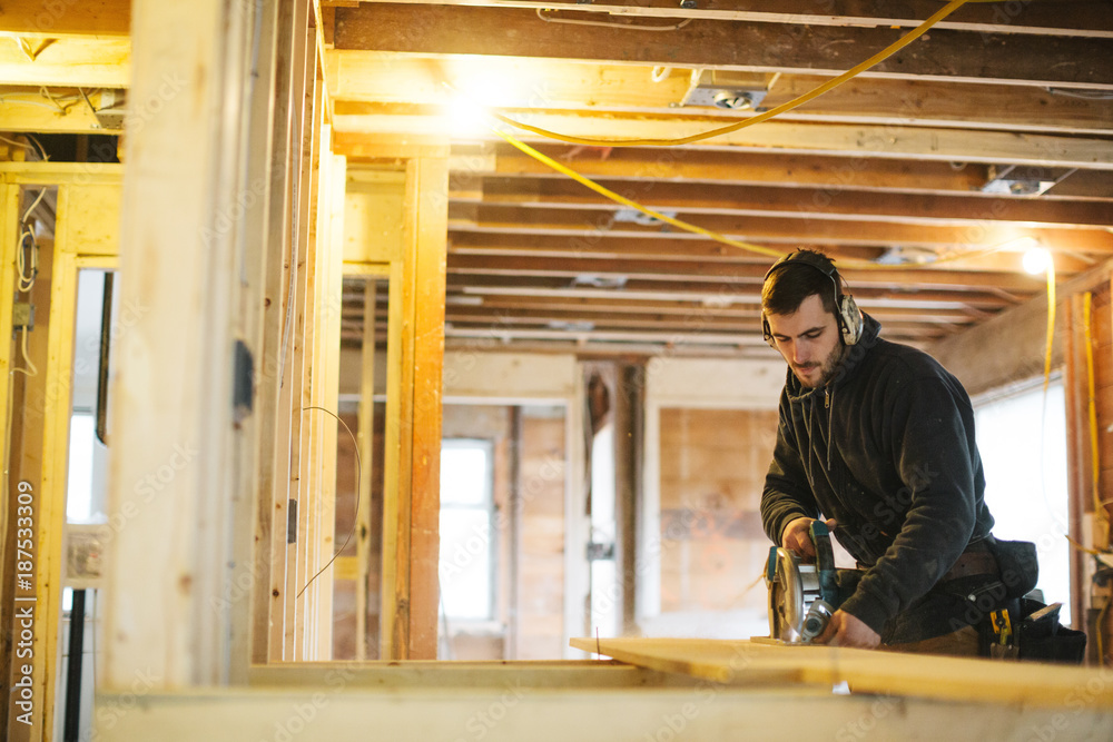 Carpenter man working on jobsite with skill saw Carpenter man working on jobsite with skill saw