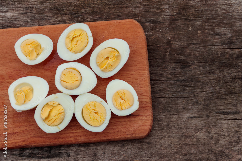 Boiled eggs on cutting board on wooden table Boiled eggs on cutting board on wooden table
