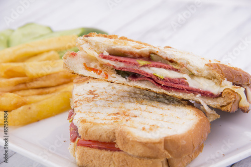 Pressed and toasted double panini with ham and cheese served on sandwich