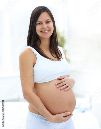 portrait of young pregnant woman on a light background. Free Download portrait of young pregnant woman on a light background. - GFXLoad