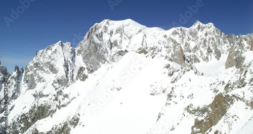 Mount Blanc snowy landscape in sunny day establisher.Mountaineering snow activity. Winter sport in alpine mountain outdoor.Panning left.Slow motion 60p 4k video