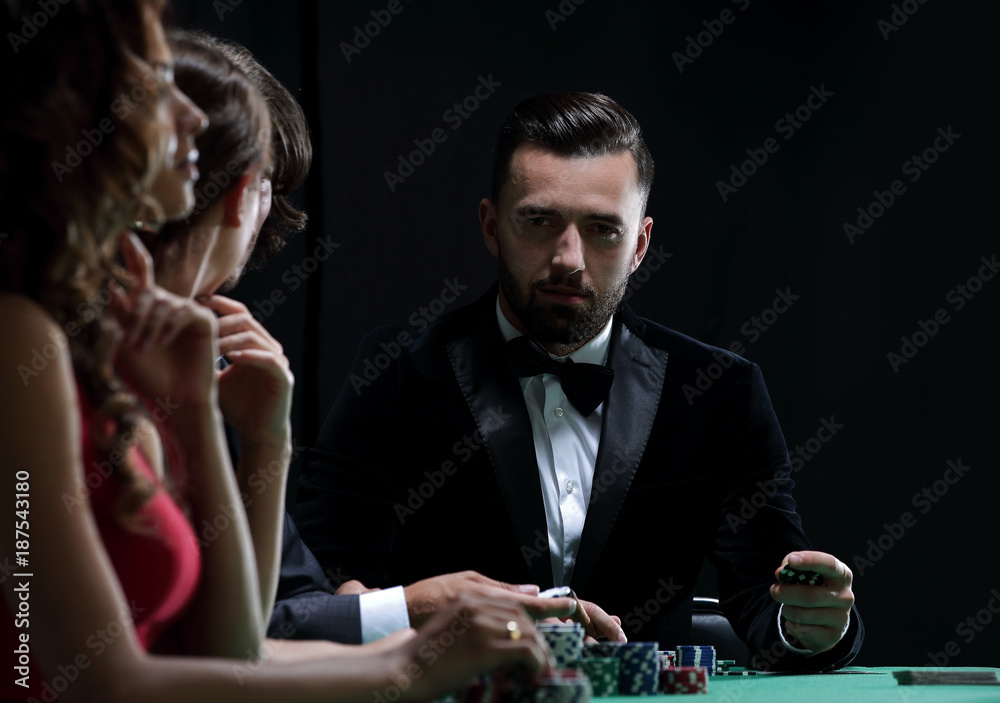 Upper class friends gambling in a casino