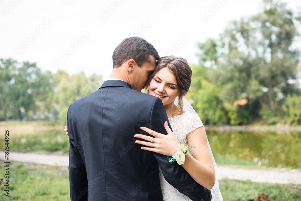 Just married couple dancing valse outdoor, free space. Bride and groom hugs, blurred green grass background. First wedding dance concept Just married couple dancing valse outdoor, free space. Bride and groom hugs, blurred green grass background. First wedding dance concept