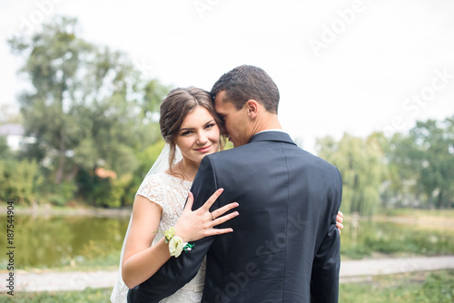 Beautifull wedding couple kissing and embracing outdoor. One beautiful wedding day