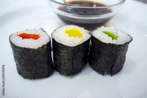 Three peppers makizushi rolls with soya sauce bowl behind