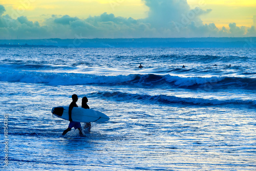 Silhouette of surfers couple