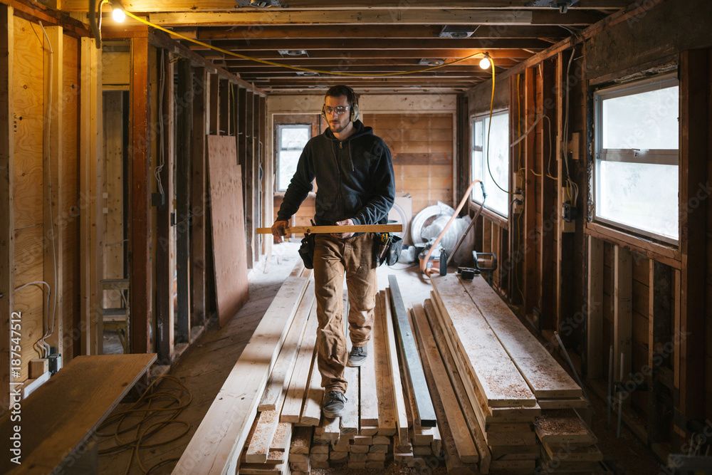 © Rob and Julia Campbell/Stocksy - Carpenter man working on jobsite