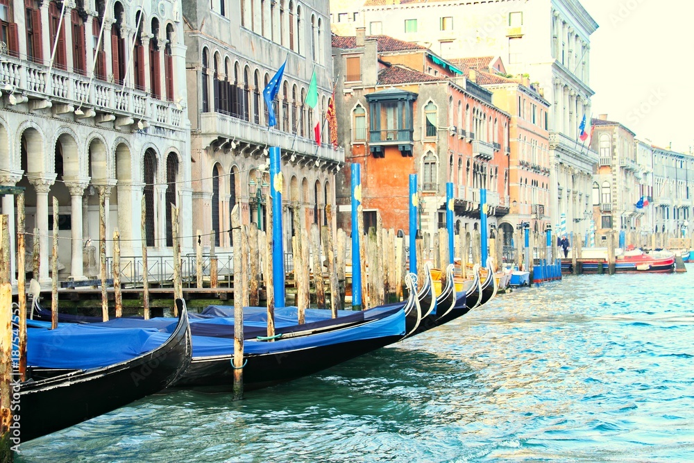 Moored gondolas in a row on the Grand Canal in Venice Italy.
