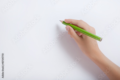 The child's hand with a pencil