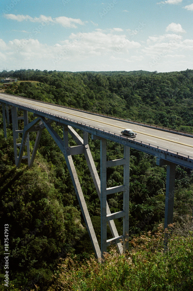 Car driving over Bacunayagua bridge Car driving over Bacunayagua bridge