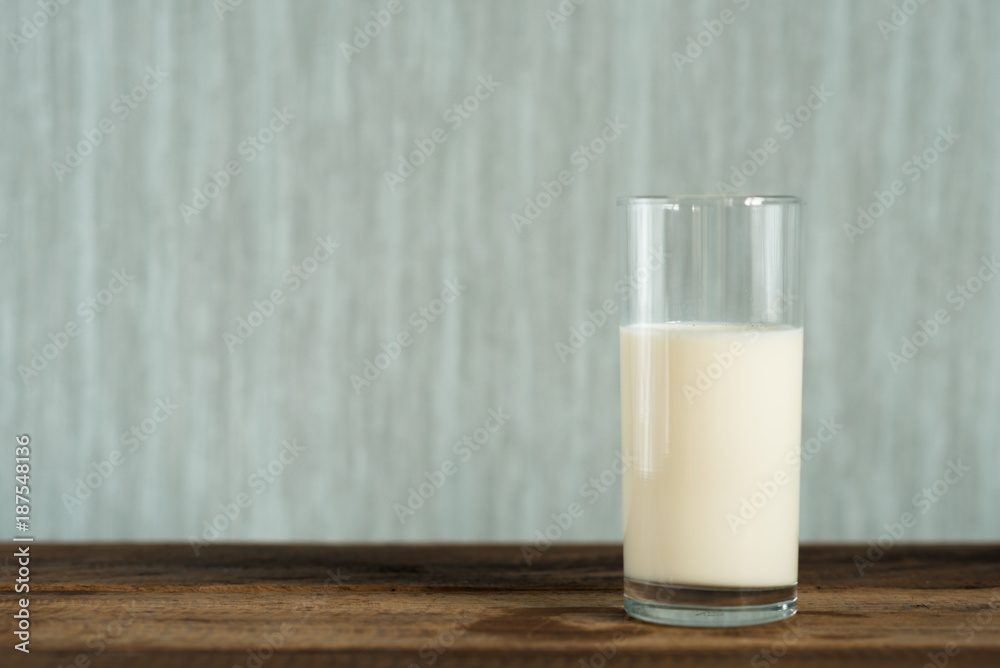 milk in a glass on wooden table background. a glass of cow milk. healthy drink concept milk in a glass on wooden table background. a glass of cow milk. healthy drink concept