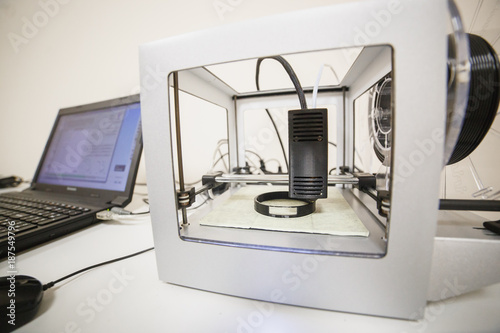 Electronic three dimensional plastic printer during work in laboratory, 3D printer, 3D printing concept photo
