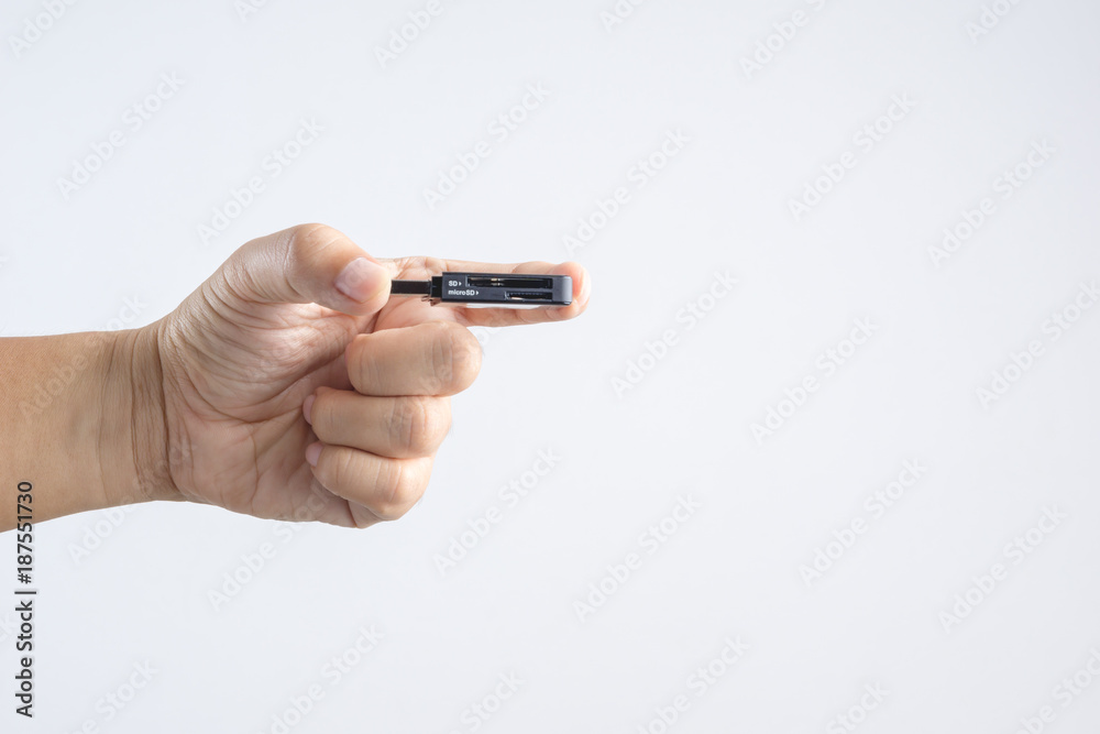 Hand holding black USB memory or storage card reader stick Hand holding black USB memory or storage card reader stick