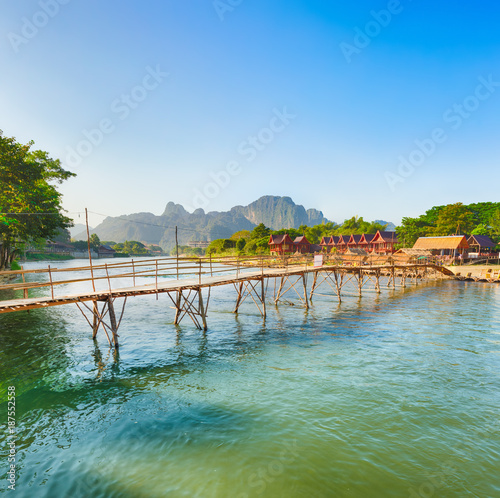 Beautiful view of a bamboo bridge. Laos landscape. © Olga Khoroshunova