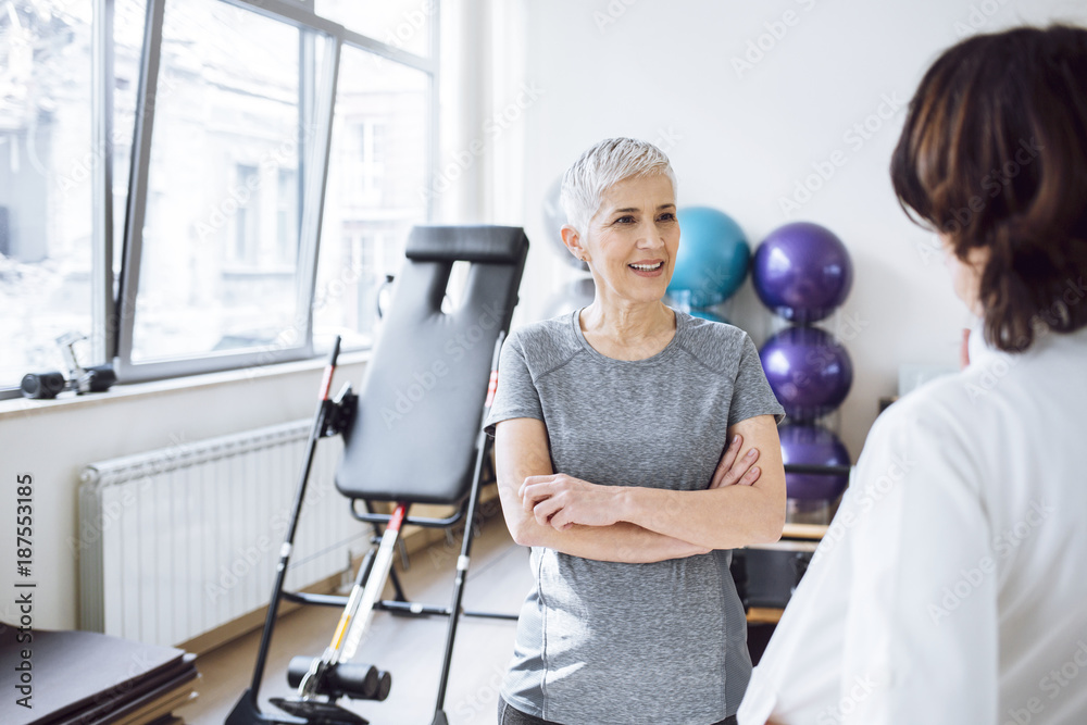 Woman Patient Talking With Doctor at Gym Woman Patient Talking With Doctor at Gym