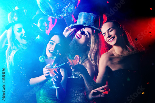 Dance party with group people . Dancing youth under influence of drugs. Women and confident casual smiling man have fun in night club. Seduce boozy woman cuddles up guy .