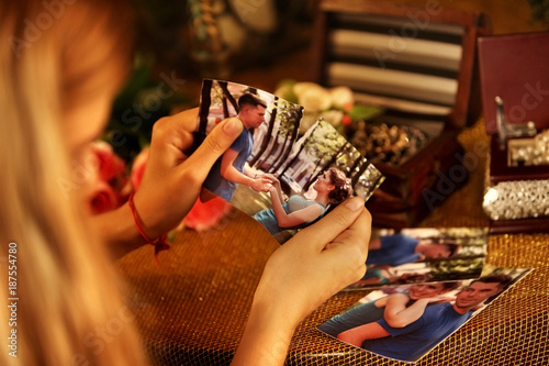 Broken heart woman. Couple break up. Woman and man quarrel. Hasty decision irreparable error. Close up of female hands tearing family pictures.