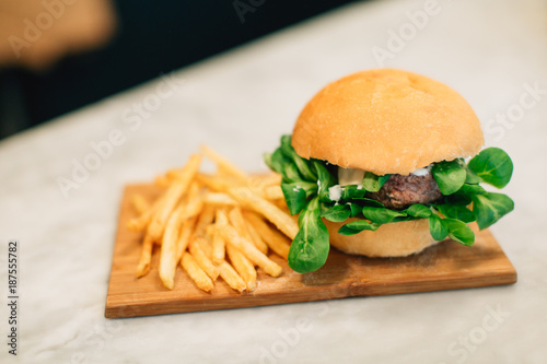 Burger with french frites in a restaurant.