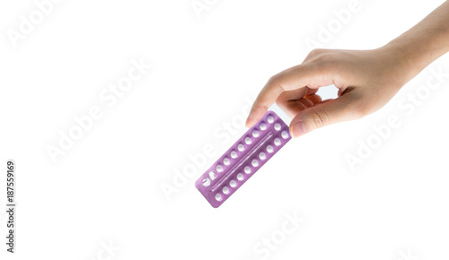 Woman hand taking birth control pills. Asian adult woman holding pack of contraceptive pills isolated on white background with clipping path. Choosing family planning with birth control pills concept