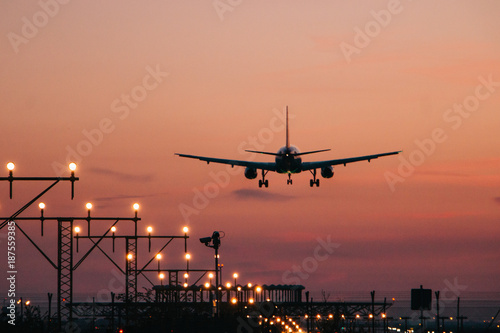 Airplane landing at sunset photo