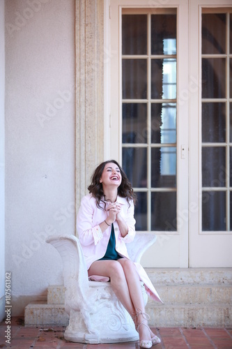 Laughing woman sitting and praying