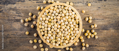 Soybean in wood bowl on wooden background.