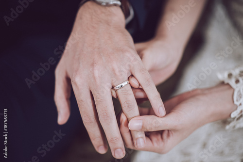 The groom is wearing a bridal ring.