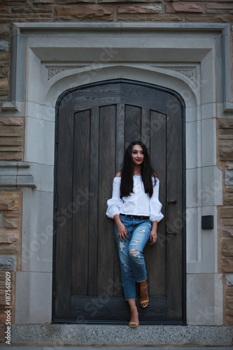 Young stylish woman leaning on door